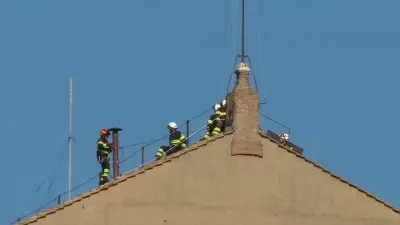 Vatican firefighters install a chimney on the roof of the Sistine Chapel for the papal election
